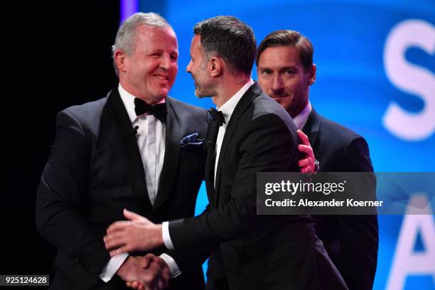 Laureus Academy Chairman Sean Fitzpatrick greets Francesco Totti and Ryans Giggs during the 2018 Laureus World Sports Awards show at Salle des...