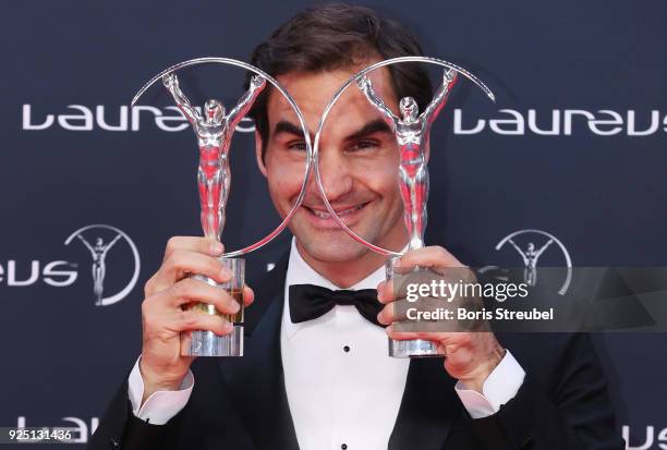 Tennis player Roger Federer holds his awards for Laureus World Comeback of the Year 2018 and Laureus World Sportsman of the Year 2018 during the...