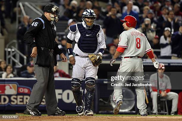 Shane Victorino of the Philadelphia Phillies reacts to the call of home plate umpire Jeff Nelson after striking out as Jose Molina of the New York...