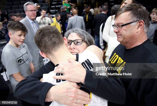 Guard Jordan Bohannon of the Iowa Hawkeyes visits with Mike and Patty Street following the match-up against the Northwestern Wildcats on February 25,...