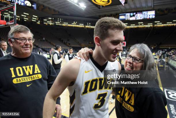 Guard Jordan Bohannon of the Iowa Hawkeyes visits with Mike and Patty Street following the match-up against the Northwestern Wildcats on February 25,...