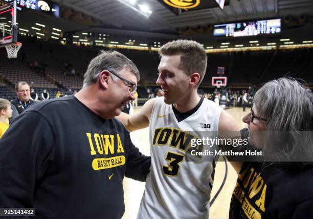 Guard Jordan Bohannon of the Iowa Hawkeyes visits with Mike and Patty Street following the match-up against the Northwestern Wildcats on February 25,...