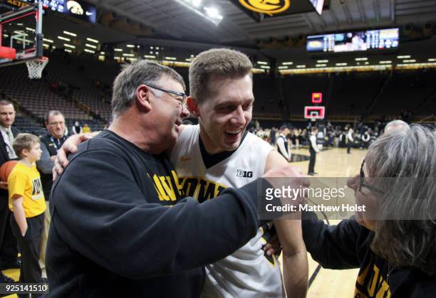 Guard Jordan Bohannon of the Iowa Hawkeyes visits with Mike and Patty Street following the match-up against the Northwestern Wildcats on February 25,...