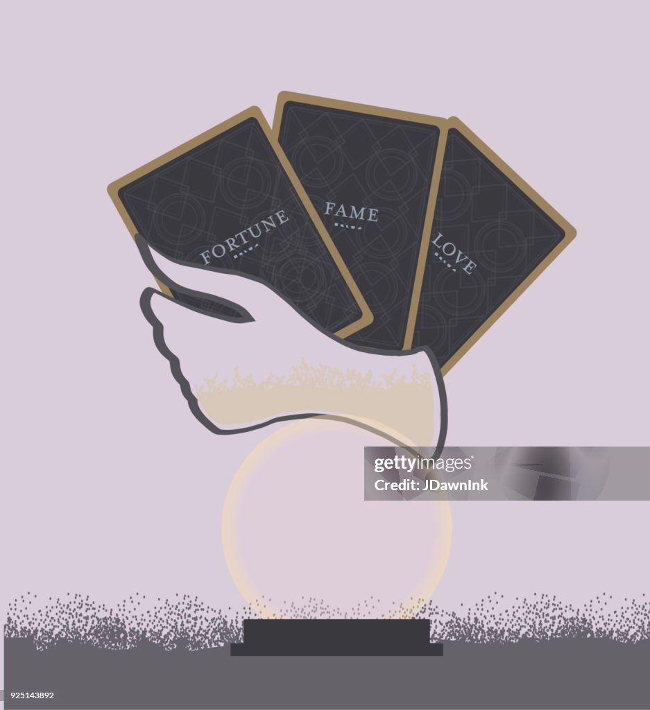 Hand holding Tarot cards with crystal ball