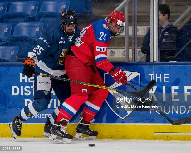 Yegor Sokolov of the Russian Nationals battles along the boards for the puck with Peetro Seppälä of the Finland Nationals during the 2018 Under-18...