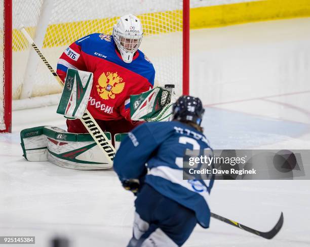 Amir Miftakhof of the Russian Nationals makes a glove save on Mikko Petman of the Finland Nationals during the 2018 Under-18 Five Nations Tournament...