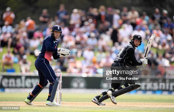 New Zealand batsman Martin Guptill cuts a ball to the boundary watched by Jos Buttler during the 2nd ODI between New Zealand and England at Bay Oval...
