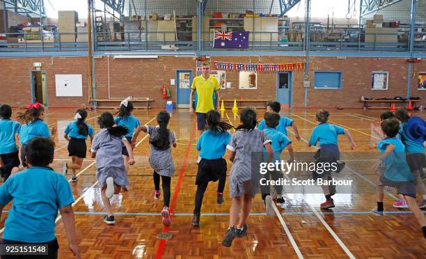 Australian long-distance runner Stewart McSweyn runs with school children as he visits them during the Commonwealth Games Keysborough Primary School...