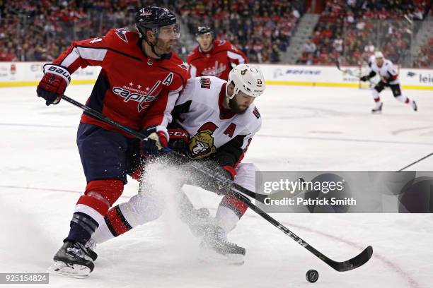 Zack Smith of the Ottawa Senators is checked by Brooks Orpik of the Washington Capitals during the third period at Capital One Arena on February 27,...
