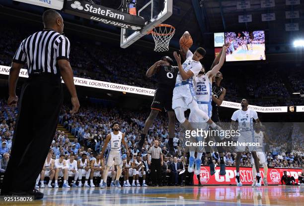 Cameron Johnson of the North Carolina Tar Heels takes a rebound away from Ja'Quan Newton of the Miami Hurricanes during their game at the Dean Smith...