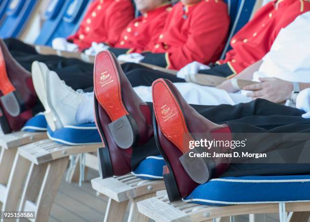 Captain Inger Klein Thorhauge with Cunard's famous Bellboys wearing R.M.Williams boots and Akubra hats on sunloungers on board Queen Elizabeth on...