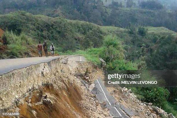 This photo taken on February 27, 2018 and received on February 28 shows damage to a road near Mendi in Papua New Guinea's highlands region after a...