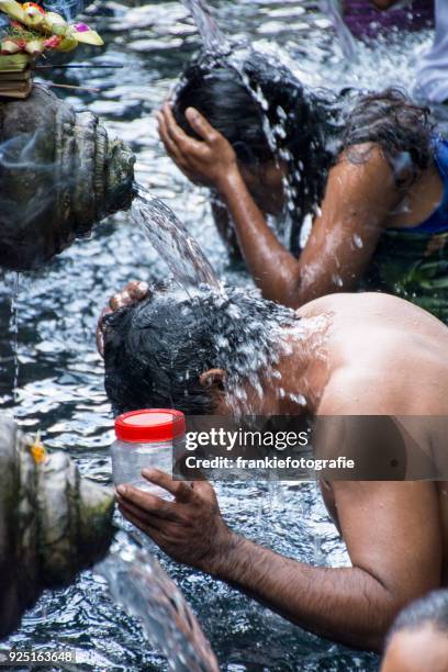 tourists bathing in the holy water at pura tirta empul temple, tampaksiring, bali, indonesia - tirta empul temple stock pictures, royalty-free photos & images