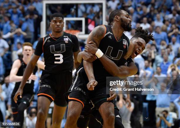 Ja'Quan Newton of the Miami Hurricanes celebrates with teammates after making the game-winning basket against the North Carolina Tar Heels during...