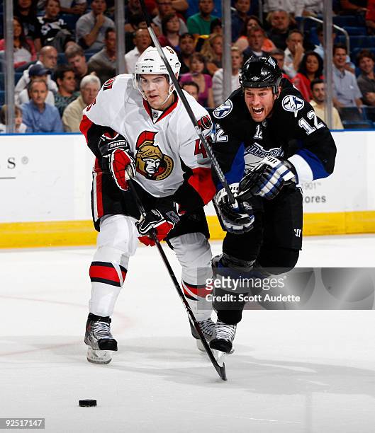 Ryan Malone of the Tampa Bay Lightning shoots the puck against Alexandre Picard of the Ottawa Senators at the St. Pete Times Forum on October 29,...