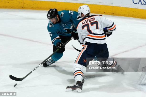 Eric Fehr of the San Jose Sharks handles the puck in front of Oscar Klefbom of the Edmonton Oilers at SAP Center on February 27, 2018 in San Jose,...