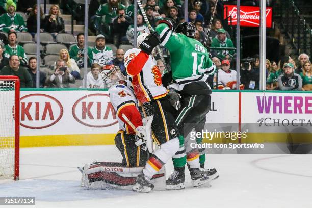 Dallas Stars left wing Jamie Benn crashes into Calgary Flames defenseman Michael Stone and goaltender Jon Gillies during the game between the Dallas...