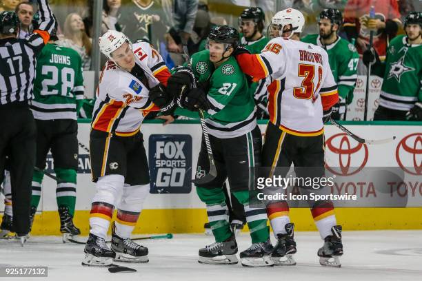 Dallas Stars left wing Antoine Roussel and Calgary Flames defenseman Michael Stone get tangled up during the game between the Dallas Stars and the...