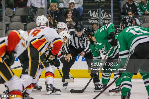 Linesman Shane Heyer gets ready to drop the puck during the game between the Dallas Stars and the Calgary Flames on February 27, 2018 at the American...