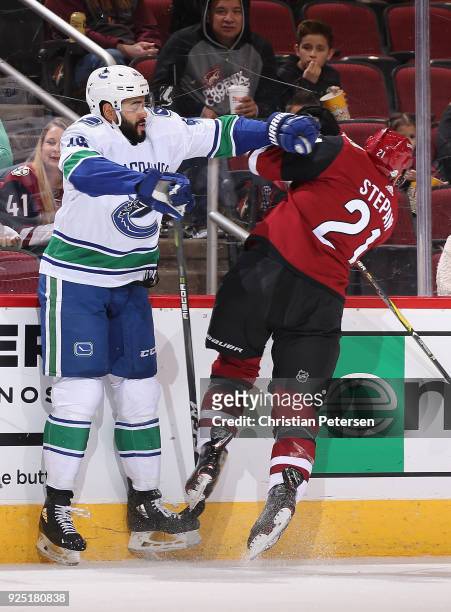 Darren Archibald of the Vancouver Canucks body checks Derek Stepan of the Arizona Coyotes during the first period of the NHL game at Gila River Arena...