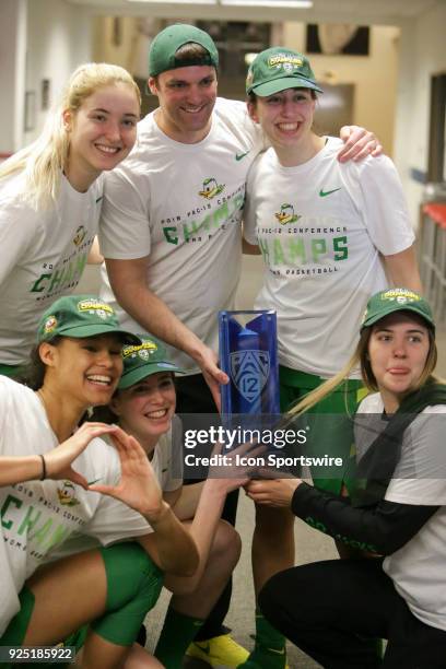 Oregon Ducks poses with the trophy after winning Pac-12 regular season title during the a college women's basketball game between Oregon Ducks and...