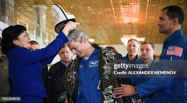 Astronaut Mark Vande Hei of NASA receives a traditional Kazakh hat after a press conference in Dzhezkazgan on February 28, 2018. Two NASA astronauts...