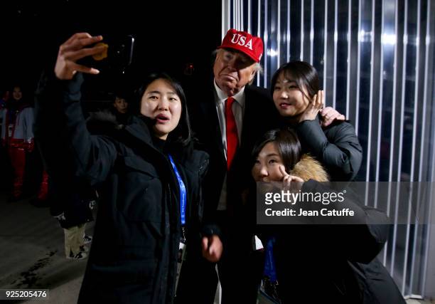An impersonator of Donald Trump poses for selfies during the closing ceremony of the 2018 PyeongChang Winter Olympic Games at PyeongChang Olympic...