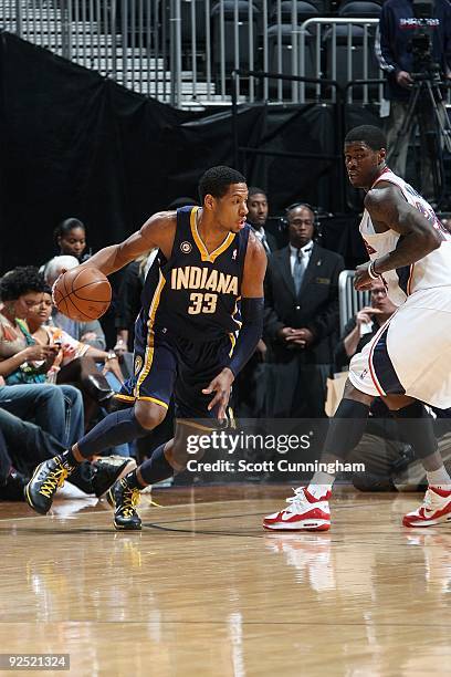 Danny Granger of the Indiana Pacers drives the ball against Marvin Williams of the Atlanta Hawks during the game on October 28, 2009 at Philips Arena...