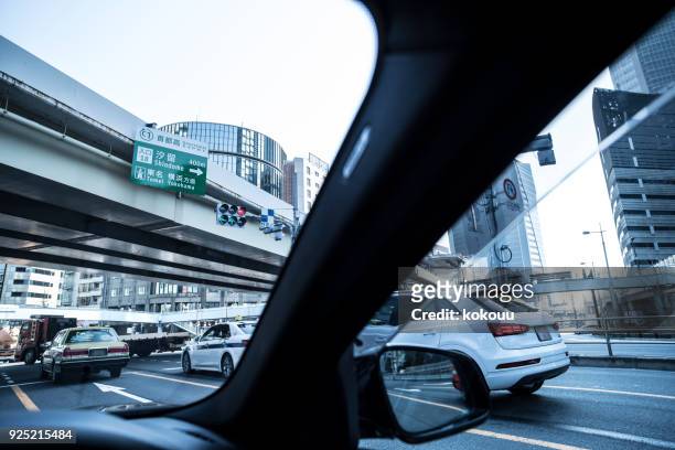 downtown from inside the car. - japanese exit sign stock pictures, royalty-free photos & images