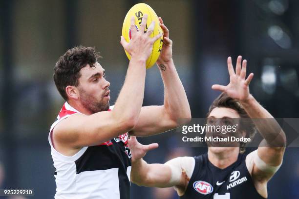 Paddy McCartin of the Saints marks the ball against Caleb Marchbank of the Blues during the JLT Community Series AFL match between the Carlton Blues...