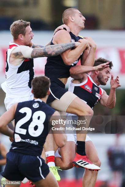 Liam Jones of the Blues competes for the ball against Tim Membrey and Maverick Weller of the Saints during the JLT Community Series AFL match between...