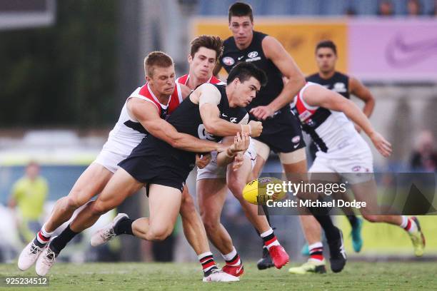 Sebastian Ross of the Saints tackles Matthew Kennedy of the Blues during the JLT Community Series AFL match between the Carlton Blues and the St...