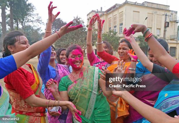 Students throwing color powder onto each other in Visva-Bharati University campus during Basanta Utsav to welcome spring. The spring is the queen of...
