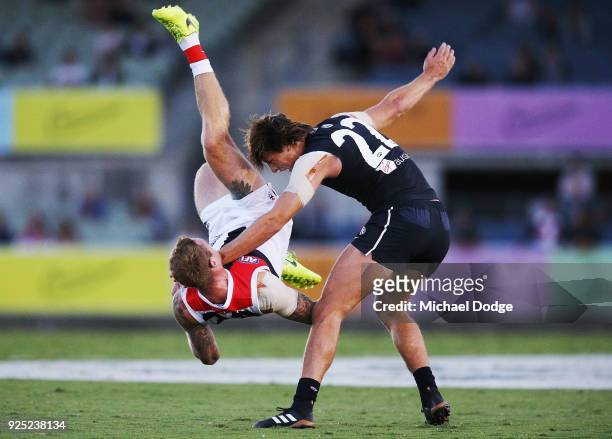 Tim Membrey of the Saints tumbles over Caleb Marchbank of the Blues during the JLT Community Series AFL match between the Carlton Blues and the St...