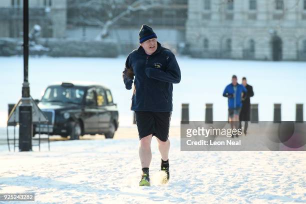British Foreign Secretary Boris Johnson jogs through the snow near St James Park on February 28, 2018 in London, England. A letter from Mr Johnson to...