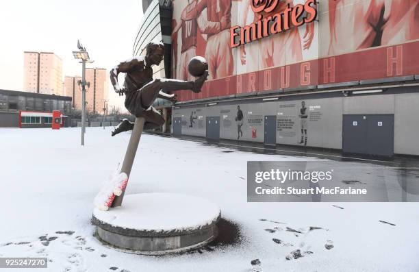 Snow covers the Dennis Bergkamp statue at Emirates Stadium on February 28, 2018 in London, England.