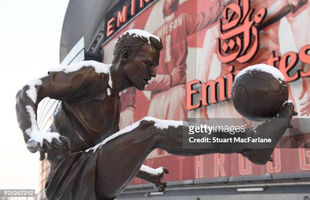 Snow covers the Dennis Bergkamp statue at Emirates Stadium on February 28, 2018 in London, England.
