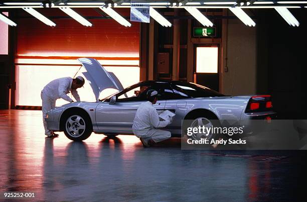 workers carrying out quality inspection on car - sports car interior stock pictures, royalty-free photos & images