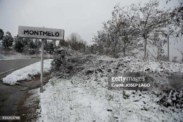 Snow covers the Montmelo sign during a snowfall at the Circuit de Catalunya on February 28, 2018 in Montmelo, on the outskirts of Barcelona, during...