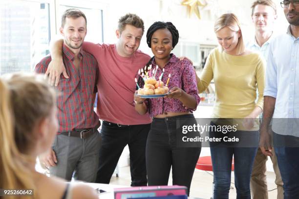 woman being given birthday cake in office - work donuts stock pictures, royalty-free photos & images