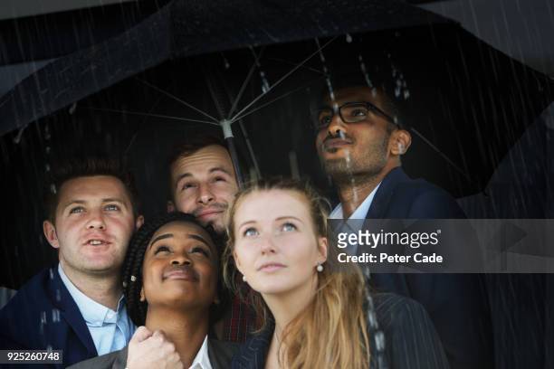 raining umbrella - businesswoman under stock-fotos und bilder