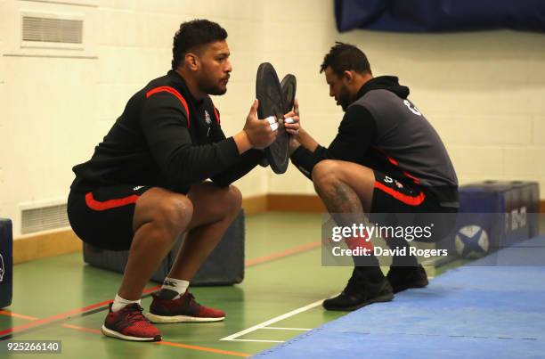 Nathan Huhges stretches with team mate Courtney Lawes during the England conditioning session held at Nuffield Health Centre on February 28, 2018 in...