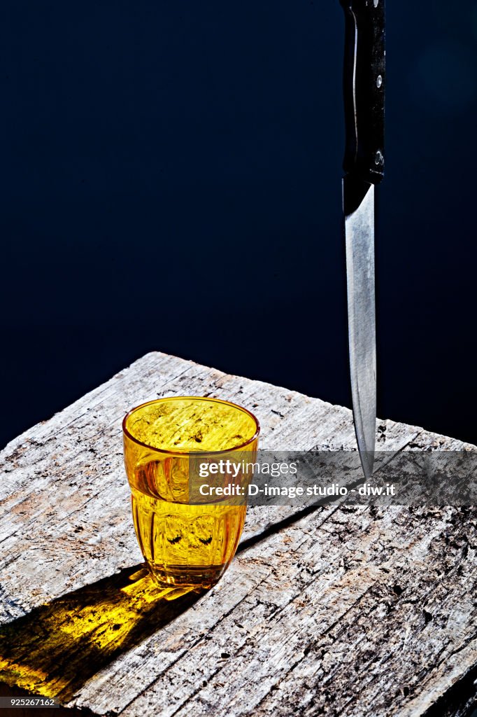 Yellow glass and knife