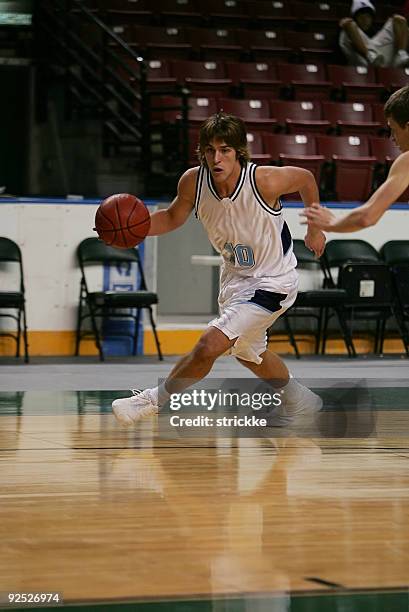 attractive male basketball player drives baseline - overtime sport stock pictures, royalty-free photos & images