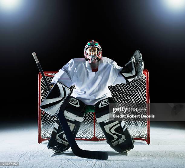 ice hockey goal keeper in front of goal - goaltender ice hockey player stock-fotos und bilder