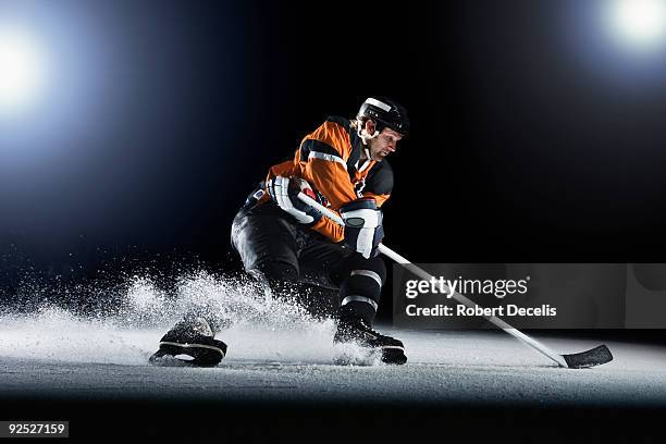 ice hockey player skating with puck. - ijshockeystick stockfoto's en -beelden