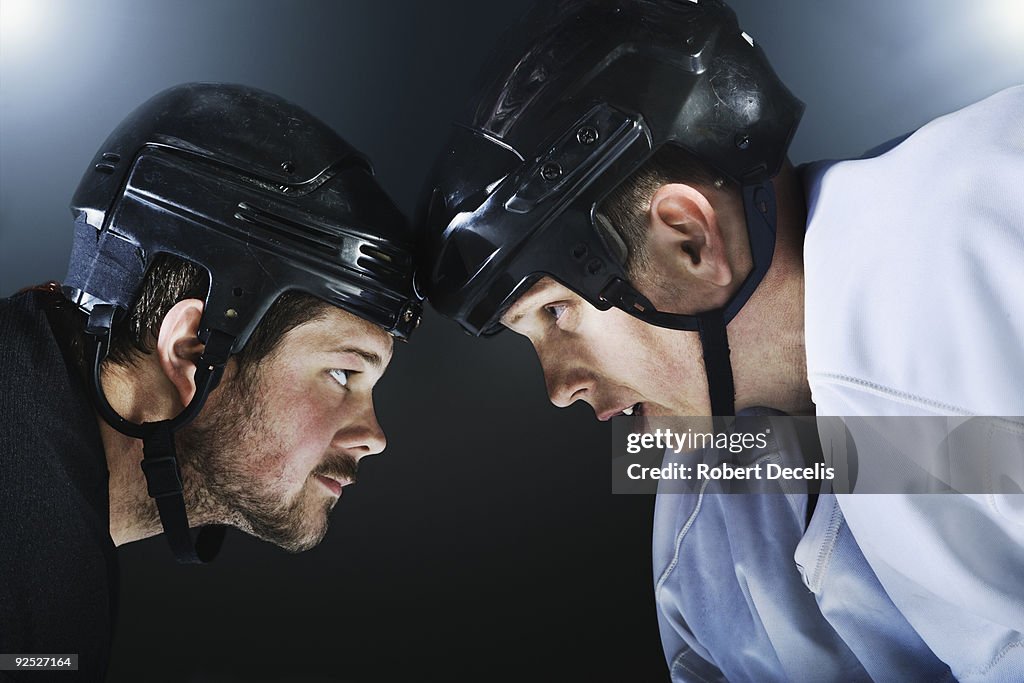 Two ice hockey players facing off.