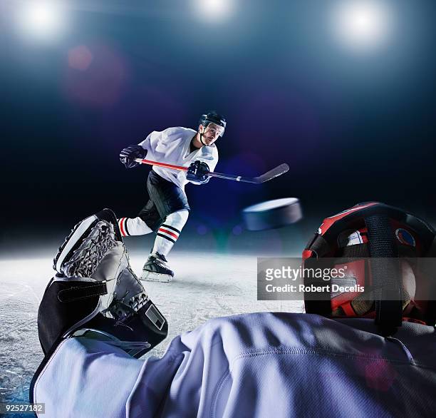 ice hockey player shooting goal - ijshockeystick stockfoto's en -beelden