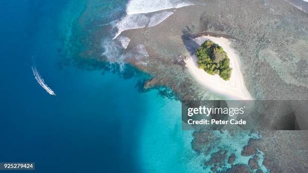 boat off of tropical island - papua new guinea beach stock pictures, royalty-free photos & images