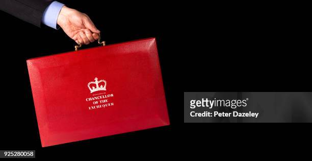 In this photo illustration, a Man holds the Chancellor of the Exchequers case budget box held against black background on February 27, 2018 in...